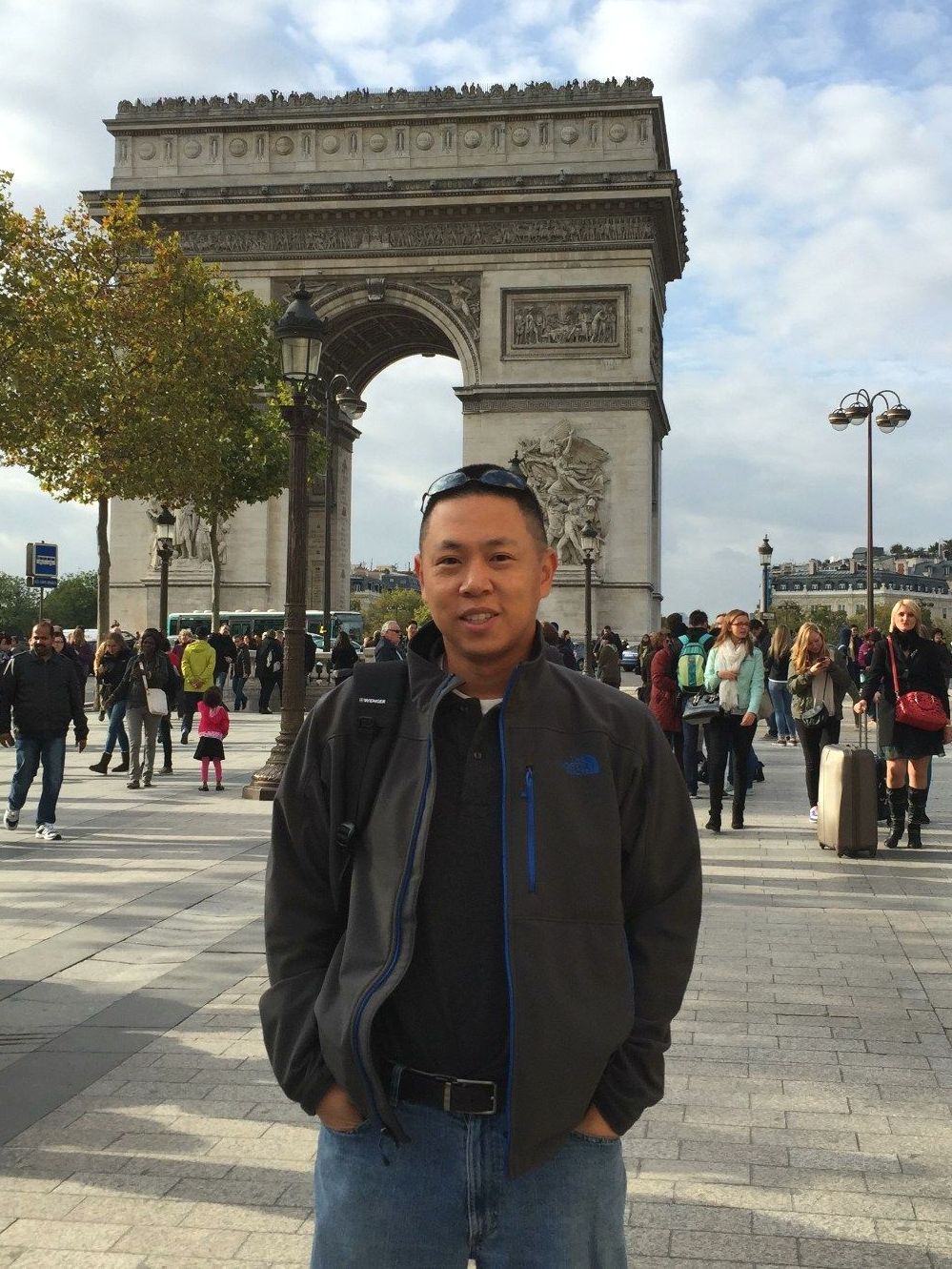 A man standing in front of a large archway